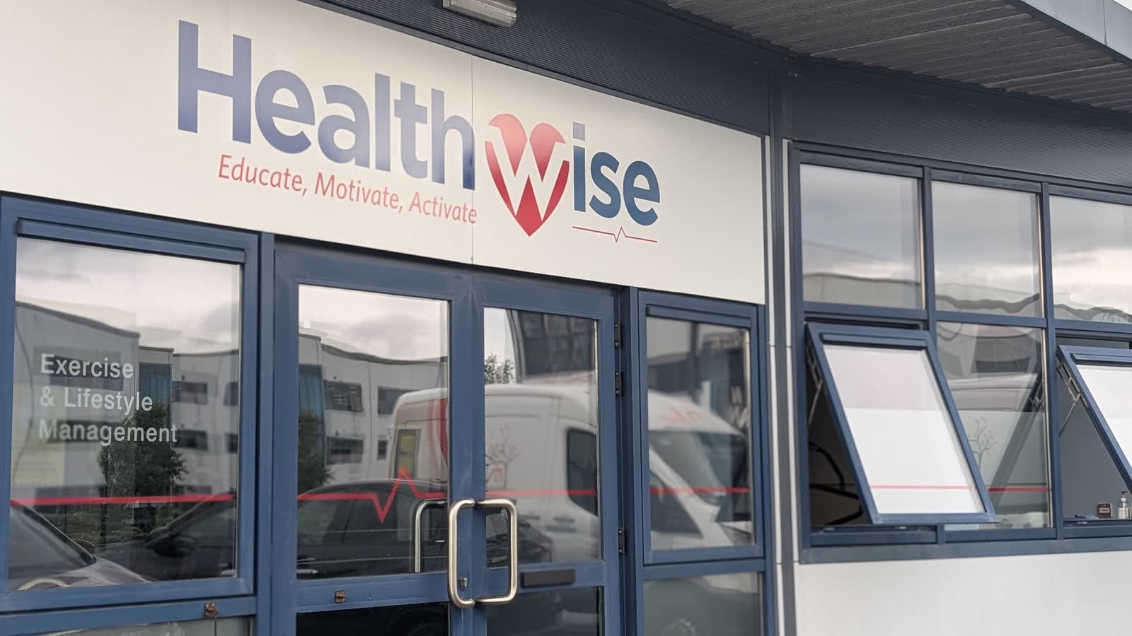 The Healthwise sign over the studio door, with the red pulse line across the glass